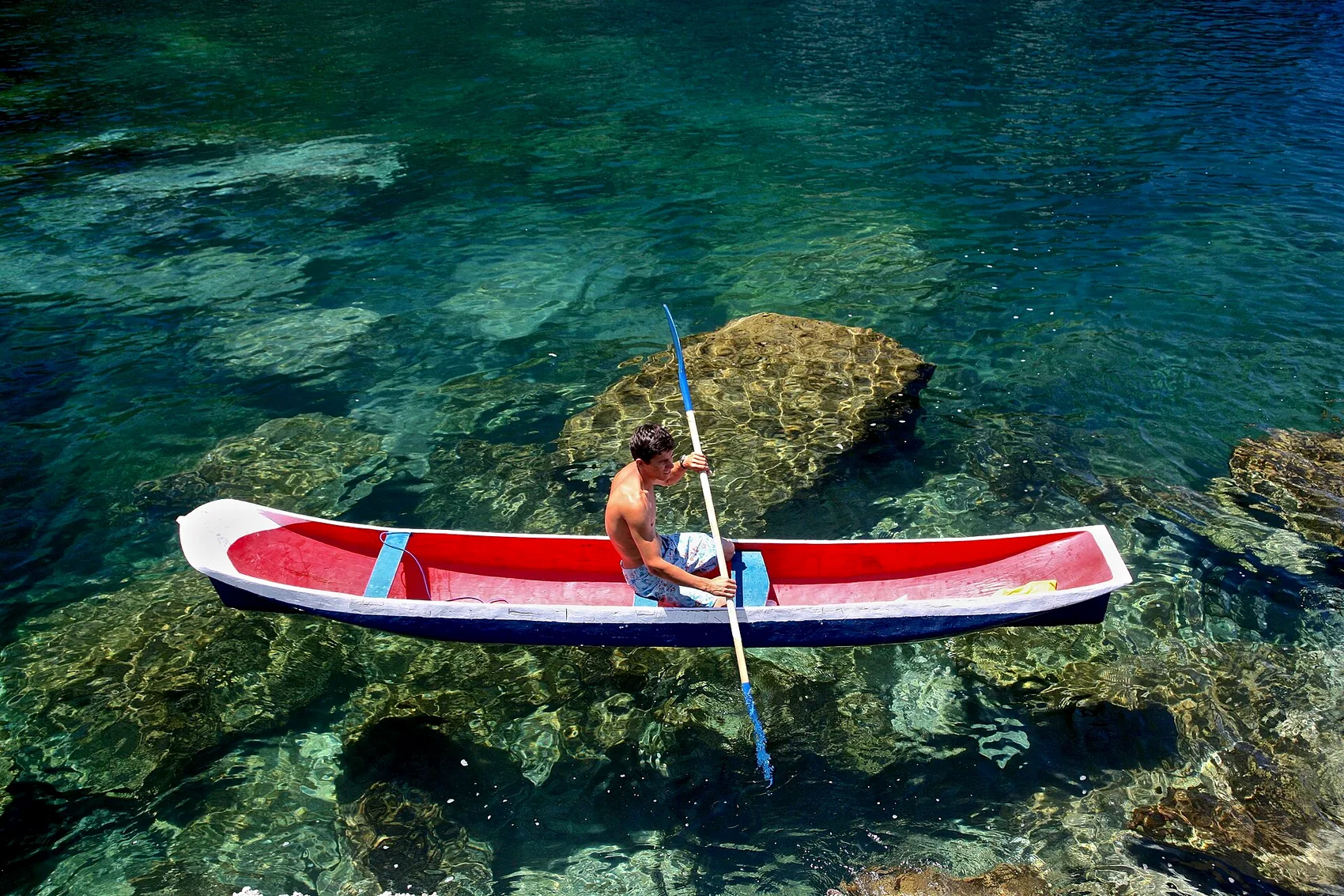 A caiçara fisherman and a dugout canoe